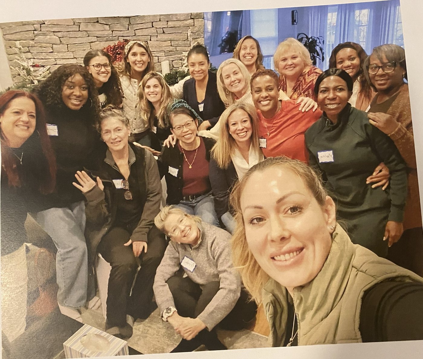 A group of smiling women gathered close together for a photo